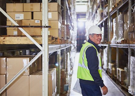 simsearch:6124-08820953,k - Portrait smiling worker in distribution warehouse aisle Stock Photo - Premium Royalty-Free, Code: 6124-08820959