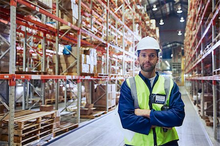 simsearch:400-04167547,k - Portrait confident worker with arms crossed in distribution warehouse Stock Photo - Premium Royalty-Free, Code: 6124-08820925