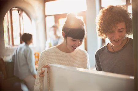 females opening doors - Young couple opening refrigerator in kitchen Stock Photo - Premium Royalty-Free, Code: 6124-08821075