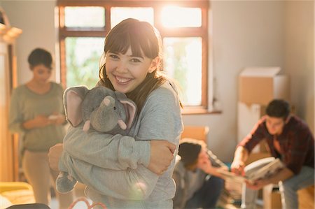 simsearch:649-06844687,k - Portrait smiling young woman hugging stuffed elephant Stock Photo - Premium Royalty-Free, Code: 6124-08821039