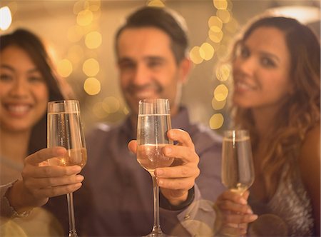 Portrait friends toasting champagne flutes Stock Photo - Premium Royalty-Free, Code: 6124-08946053