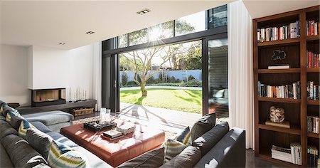 simsearch:6124-08907870,k - Sunny home showcase interior living room open to sunny yard Stock Photo - Premium Royalty-Free, Code: 6124-08907865