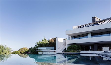 simsearch:6124-08908175,k - Tranquil home showcase interior with infinity pool under sunny blue sky Stock Photo - Premium Royalty-Free, Code: 6124-08907991