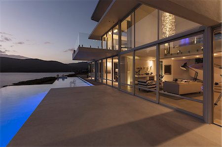 simsearch:6113-06753907,k - Tranquil modern luxury home showcase exterior with lap pool and dusk ocean view Stock Photo - Premium Royalty-Free, Code: 6124-08908156