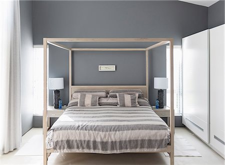 simsearch:6124-08170529,k - Striped bedding on canopy bed in modern home showcase interior bedroom Foto de stock - Sin royalties Premium, Código: 6124-08908159