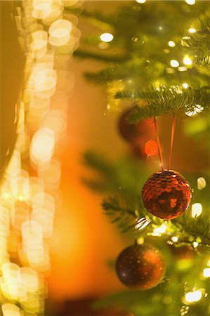 simsearch:6124-08926935,k - Red glitter ornaments hanging from Christmas tree with string lights Stock Photo - Premium Royalty-Free, Code: 6124-08926923