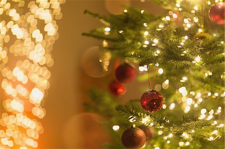 simsearch:6124-08926940,k - Red ornaments hanging from Christmas tree with string lights Foto de stock - Sin royalties Premium, Código: 6124-08926920