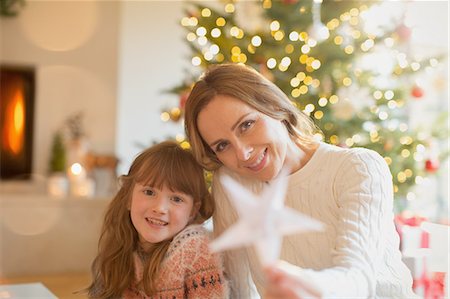 simsearch:6124-08926935,k - Portrait smiling mother and daughter holding Christmas star Stock Photo - Premium Royalty-Free, Code: 6124-08926928