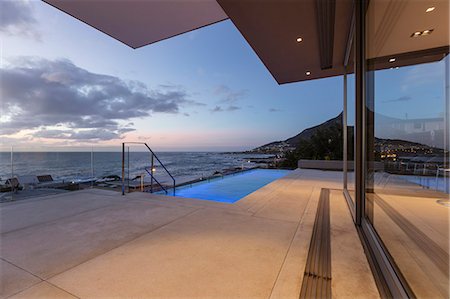 simsearch:6124-08927074,k - Patio with lap swimming pool and ocean view at dusk Stock Photo - Premium Royalty-Free, Code: 6124-08927074