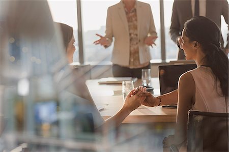 simsearch:6113-09111915,k - Businesswomen shaking hands in conference room meeting Stock Photo - Premium Royalty-Free, Code: 6124-09056407