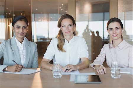 simsearch:6113-07790910,k - Portrait smiling, confident businesswomen working in conference room meeting Stock Photo - Premium Royalty-Free, Code: 6124-09056506