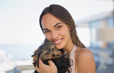 simsearch:6113-06720990,k - Portrait smiling woman cuddling small dog Stock Photo - Premium Royalty-Free, Code: 6124-09099735