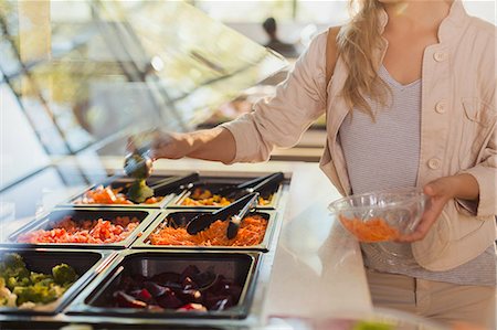 salad tongs - Young woman at salad bar in grocery store market Stock Photo - Premium Royalty-Free, Code: 6124-09004846