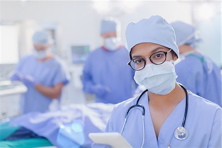 simsearch:6113-09111899,k - Portrait confident female surgeon wearing surgical mask in operating room Foto de stock - Royalty Free Premium, Número: 6124-09026421