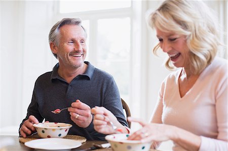 simsearch:6124-09143690,k - Smiling mature couple eating breakfast Stock Photo - Premium Royalty-Free, Code: 6124-09143750