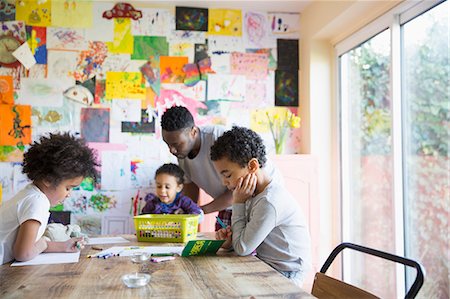 drawings of a girl and boy - Father and children coloring at dining table Stock Photo - Premium Royalty-Free, Code: 6124-09167338