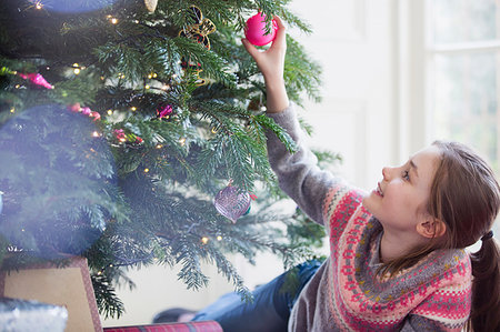 simsearch:6124-08926935,k - Curious girl touching ornament on Christmas tree Stock Photo - Premium Royalty-Free, Code: 6124-09177923
