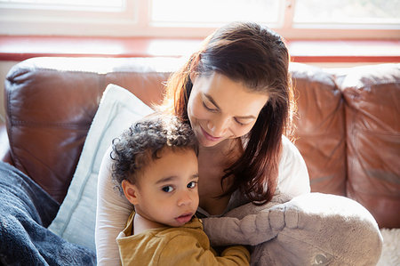 simsearch:6113-08928032,k - Mother and innocent baby son on living room sofa Stock Photo - Premium Royalty-Free, Code: 6124-09178046