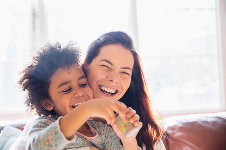 simsearch:6113-08943628,k - Laughing, carefree mother and daughter Stock Photo - Premium Royalty-Free, Code: 6124-09178052