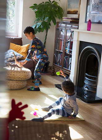 Brothers in pajamas playing with toys in living room Stock Photo - Premium Royalty-Free, Code: 6124-09178035