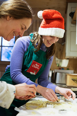 parent talking to their 16 year old - Mother and daughter in Christmas apron and Santa hat baking in kitchen Stock Photo - Premium Royalty-Free, Code: 6124-09188751