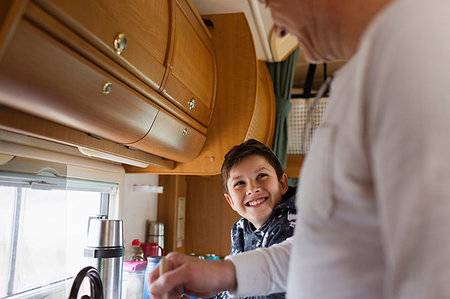 Happy father and son cooking in motor home Stock Photo - Premium Royalty-Free, Code: 6124-09188843