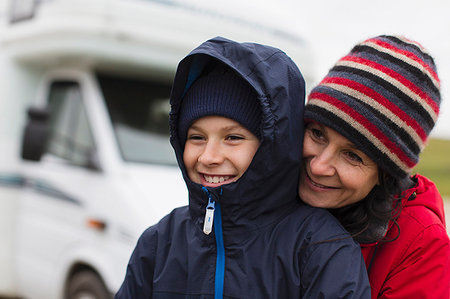 Affectionate mother and son in warm clothing hugging outside motor home Stock Photo - Premium Royalty-Free, Code: 6124-09188875