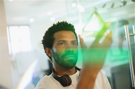 possible - Innovative male entrepreneur examining glass cube prototype Foto de stock - Sin royalties Premium, Código: 6124-09130968