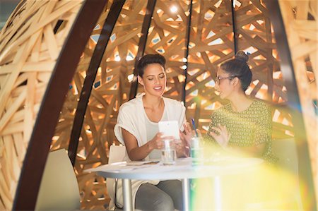 Creative businesswomen meeting, using digital tablet in creative workspace Stock Photo - Premium Royalty-Free, Code: 6124-09130980