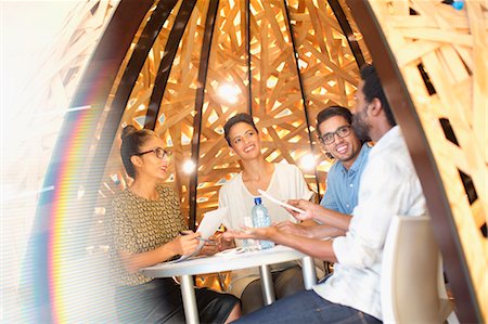 simsearch:6124-08170794,k - Creative business people meeting in creative workspace teepee Foto de stock - Sin royalties Premium, Código: 6124-09130986