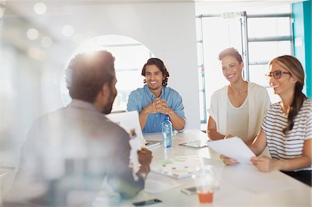 simsearch:6113-07147948,k - Smiling creative business people brainstorming, planning in conference room meeting Stock Photo - Premium Royalty-Free, Code: 6124-09131060