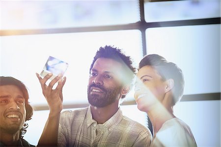 possible - Curious, innovative entrepreneurs examining glass cube prototype Stock Photo - Premium Royalty-Free, Code: 6124-09131000