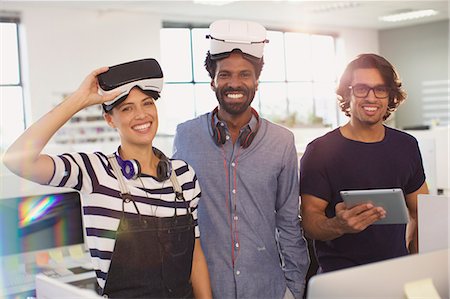 simsearch:614-07031408,k - Portrait smiling, confident computer programmers testing virtual reality simulators in office Stock Photo - Premium Royalty-Free, Code: 6124-09131006