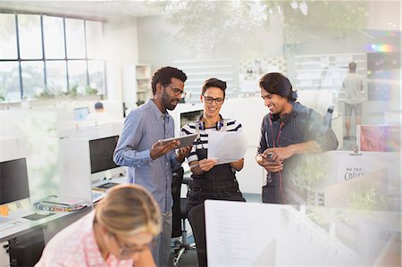 simsearch:6113-08882500,k - Creative business people with digital tablet discussing paperwork in office Stock Photo - Premium Royalty-Free, Code: 6124-09131028