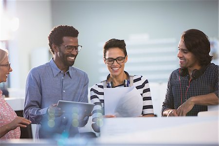 Creative business people with digital tablet planning, discussing paperwork in office Foto de stock - Sin royalties Premium, Código: 6124-09131104