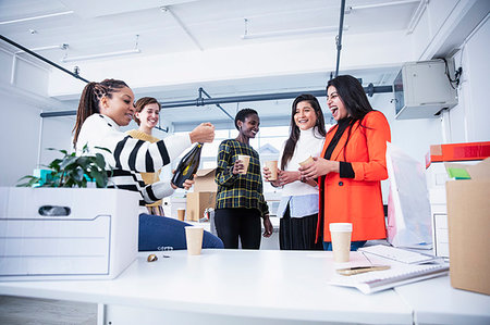 Businesswomen celebrating new office with champagne Stock Photo - Premium Royalty-Free, Code: 6124-09269788