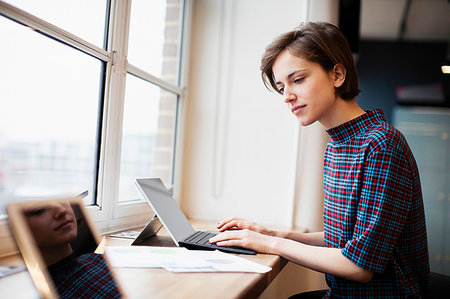 simsearch:6124-09269882,k - Businesswoman working at digital tablet in office window Stock Photo - Premium Royalty-Free, Code: 6124-09269838