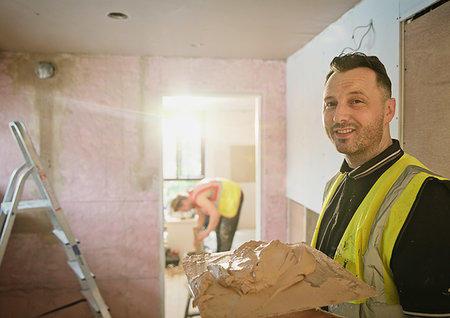 person with trowel - Portrait confident construction worker plastering Stock Photo - Premium Royalty-Free, Code: 6124-09229054