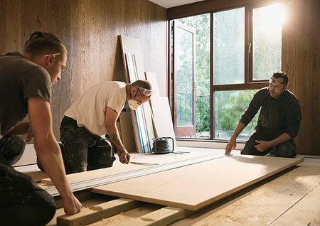 restoration equipment - Construction workers measuring wood board Stock Photo - Premium Royalty-Free, Code: 6124-09229059