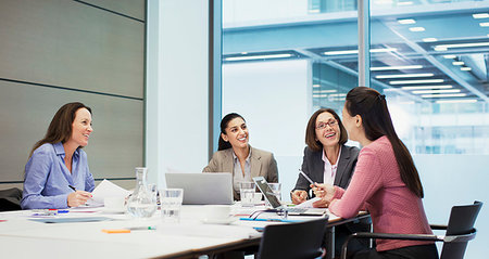 simsearch:6113-06899028,k - Happy businesswomen talking in conference room meeting Stock Photo - Premium Royalty-Free, Code: 6124-09229144