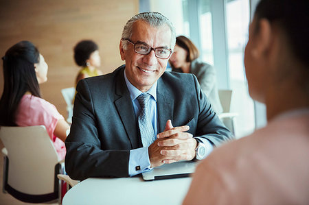 Smiling businessman listening to colleague in cafeteria Stock Photo - Premium Royalty-Free, Code: 6124-09229106