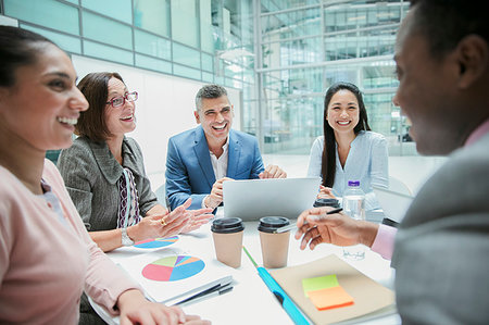 simsearch:6113-08882584,k - Happy business people laughing in meeting Stock Photo - Premium Royalty-Free, Code: 6124-09229134