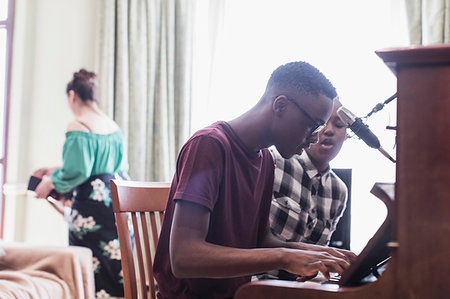 Teenage brother and sister playing piano and singing Stock Photo - Premium Royalty-Free, Code: 6124-09239268