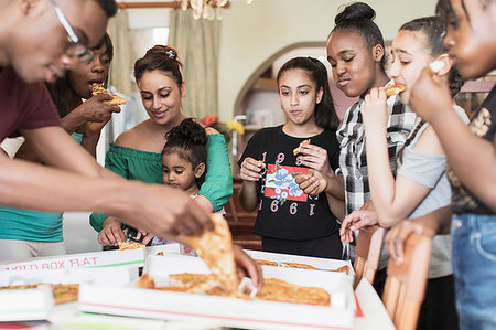 parents teenagers eating - Family eating pizza Stock Photo - Premium Royalty-Free, Code: 6124-09239349