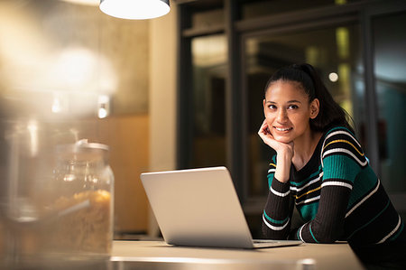 simsearch:400-04443819,k - Portrait smiling, confident woman using laptop at home at night Stock Photo - Premium Royalty-Free, Code: 6124-09239489