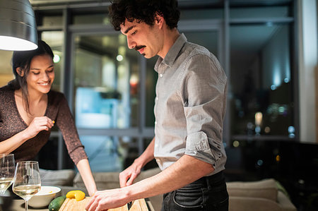 simsearch:6113-08550102,k - Couple cooking dinner in apartment kitchen at night Stock Photo - Premium Royalty-Free, Code: 6124-09239506