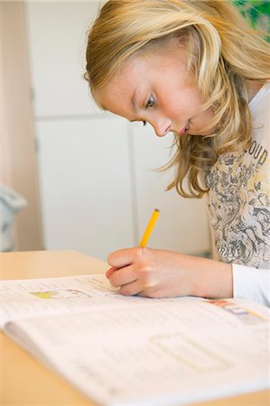 simsearch:6111-06727615,k - View of schoolgirl (10-11) writting Photographie de stock - Premium Libres de Droits, Code: 6126-08580532