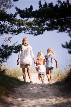 swedish - Sweden, Gotland, Faro, Skar, Mother with son (2-3) and daughters (8-9, 10-11) walking along footpath Stock Photo - Premium Royalty-Free, Code: 6126-08642802