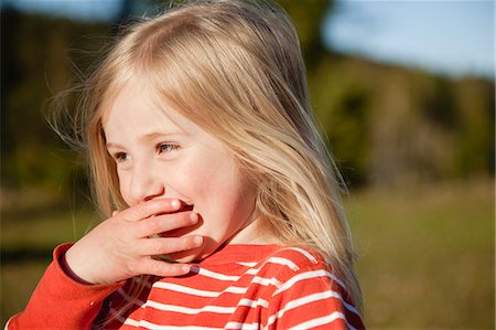 simsearch:6126-08644715,k - Sweden, Medelpad, Portrait of blonde girl (2-3) covering mouth with hand Foto de stock - Sin royalties Premium, Código: 6126-08642971