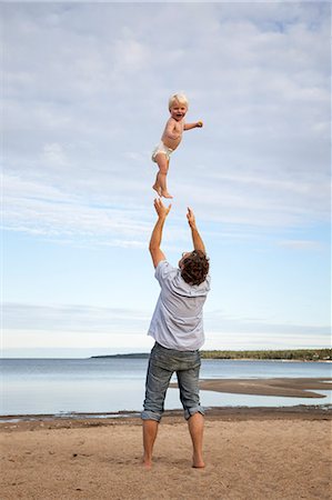 dad baby nappy - Sweden, Medelpad, Juniskarr, Man throwing son (2-3) in air Stock Photo - Premium Royalty-Free, Code: 6126-08642974